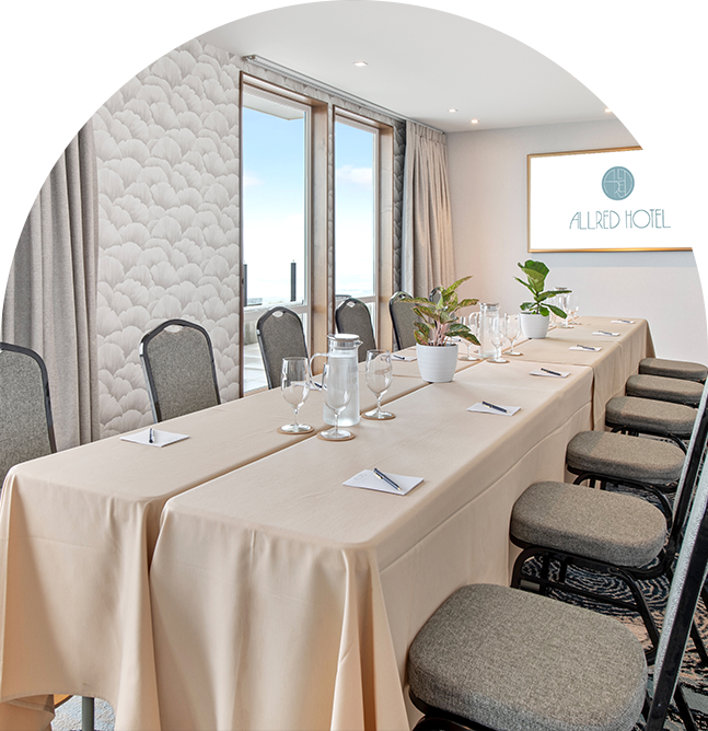 a long table with chairs and a table with a white tablecloth