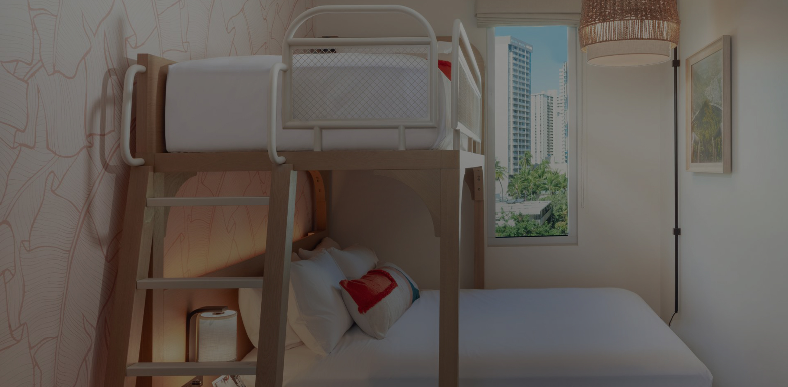 a bunk bed in a room with a window and city view