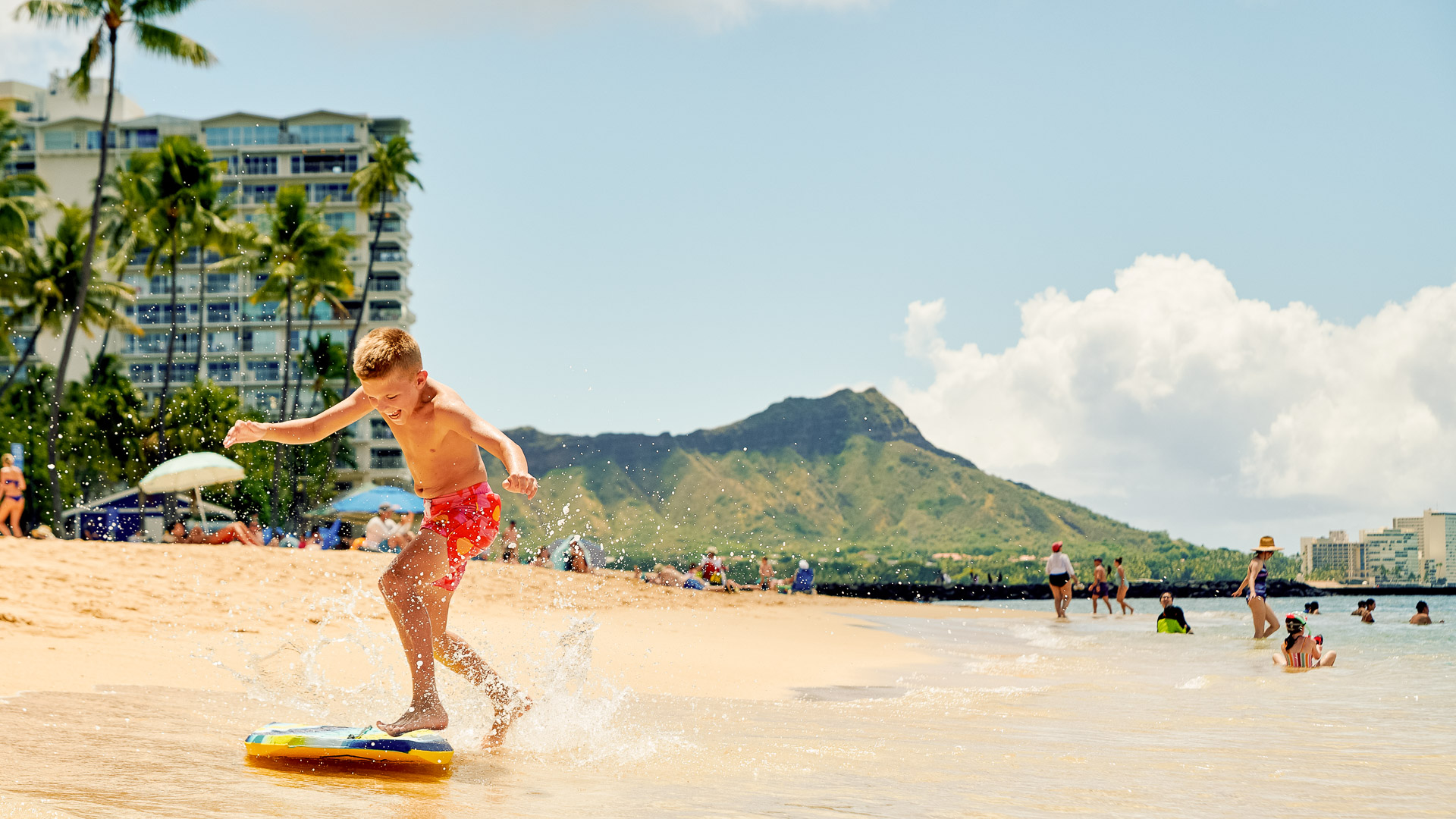 a boy on a boogie board on a beach