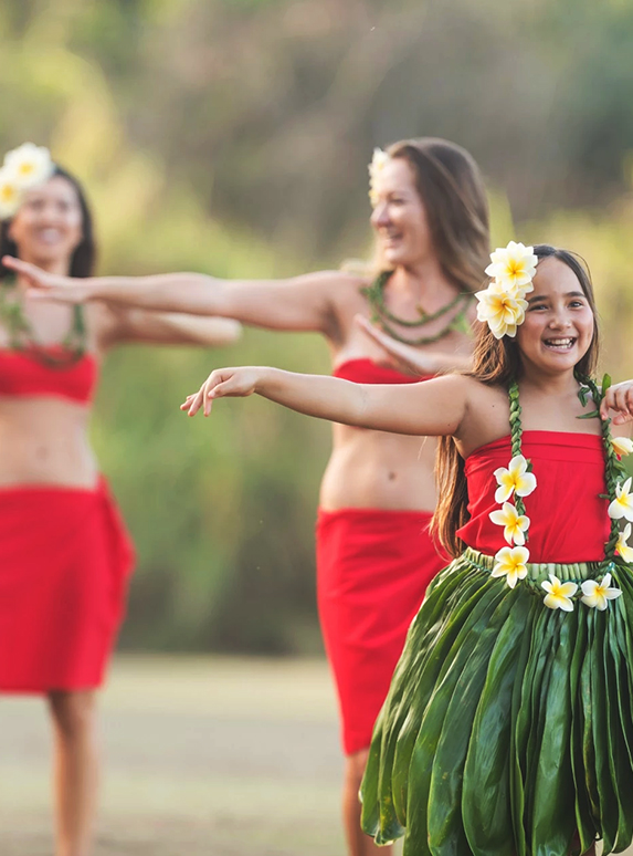 a group of women dancing hula