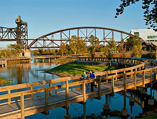 a bridge over water with people walking