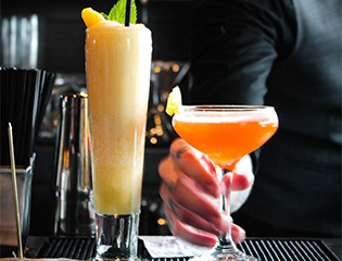 a hand holding a glass of drink