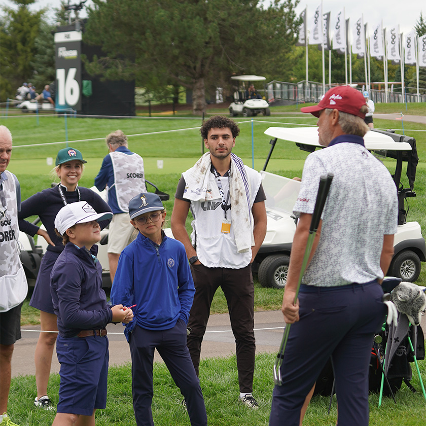 a group of people standing on grass