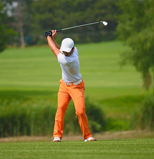 a man swinging a golf club