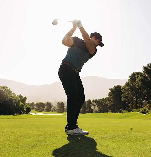 a man swinging a golf club