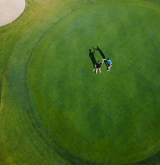 a couple of people on a golf course