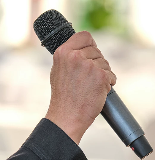 a hand holding a microphone