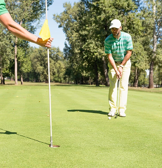 a man putting on a golf course