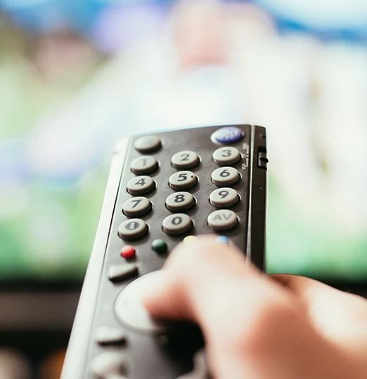 a hand holding a remote control