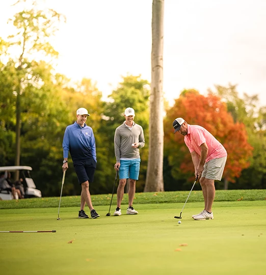 a group of men playing golf