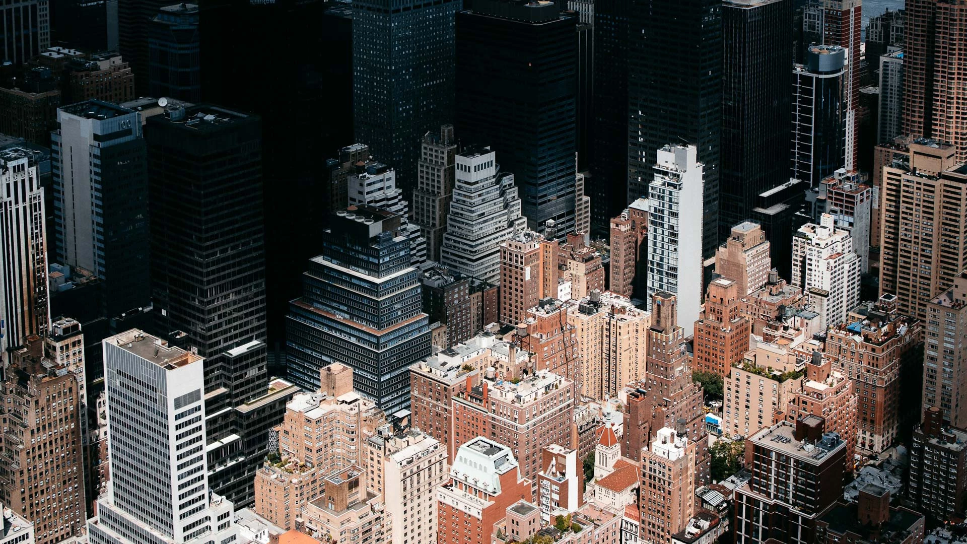 Aerial view of a densely populated cityscape with numerous high-rise buildings.