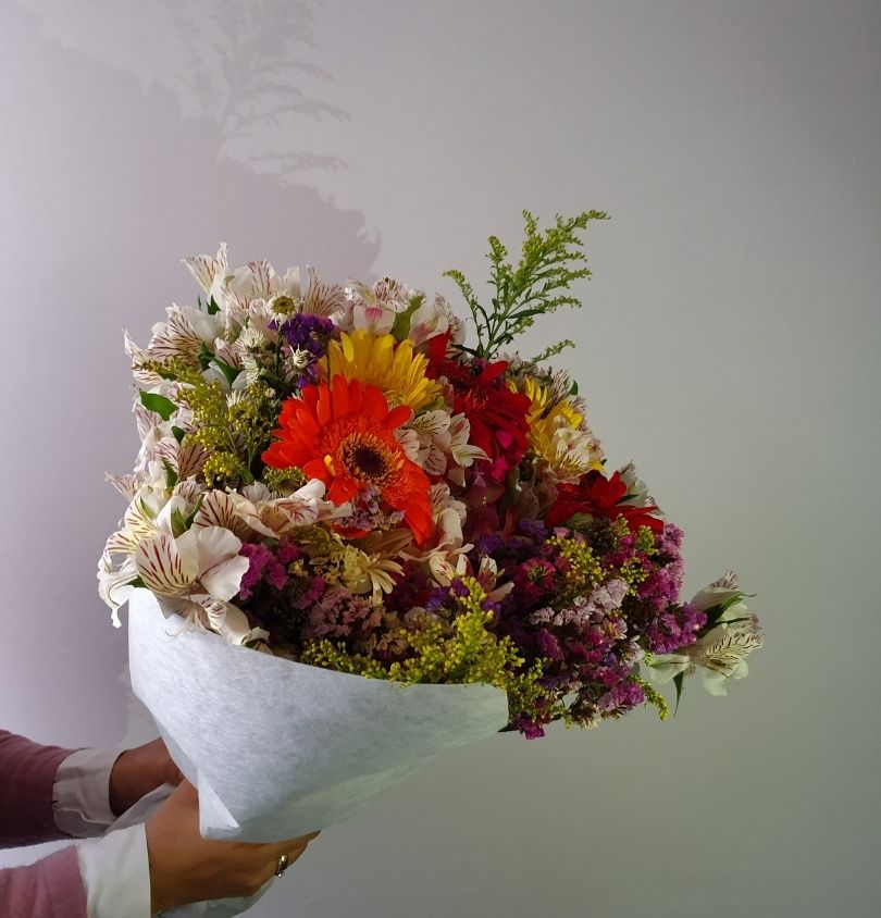 a person holding a bouquet of flowers