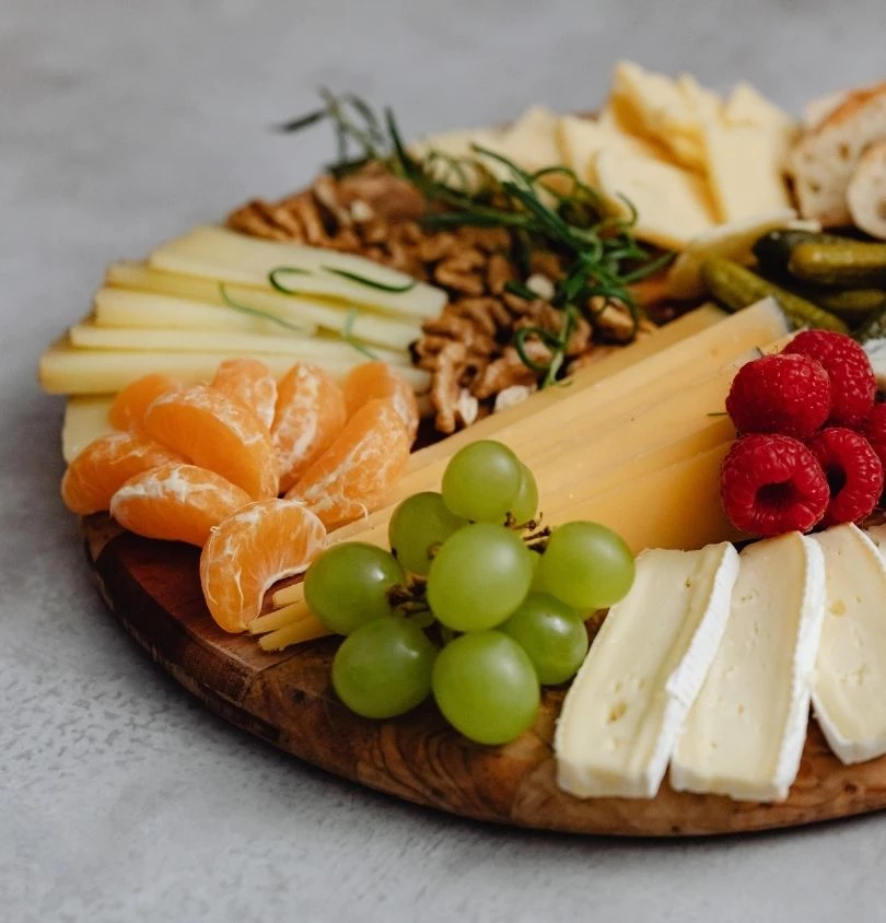 a platter of cheese and fruit