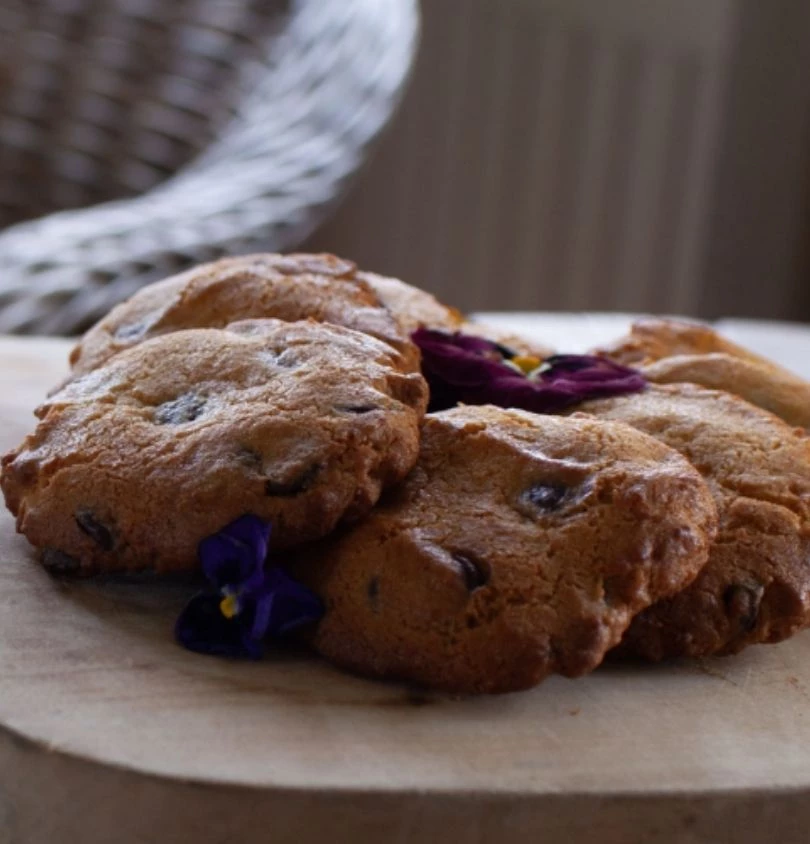 a group of cookies on a wood plate