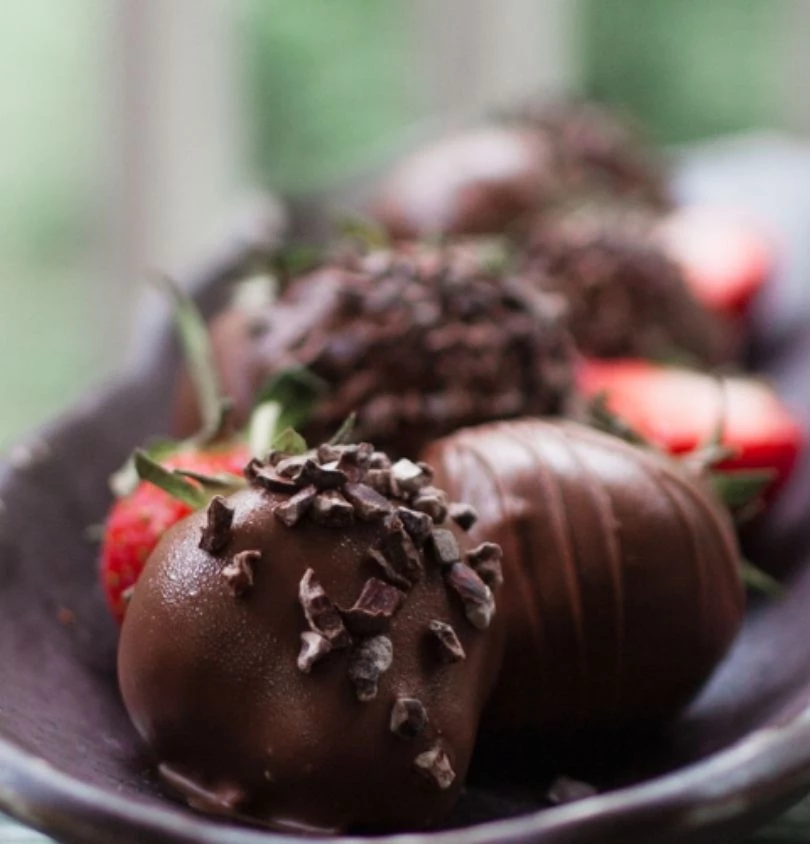 a plate of chocolate covered strawberries