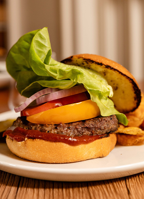 a burger with lettuce and tomato on a plate
