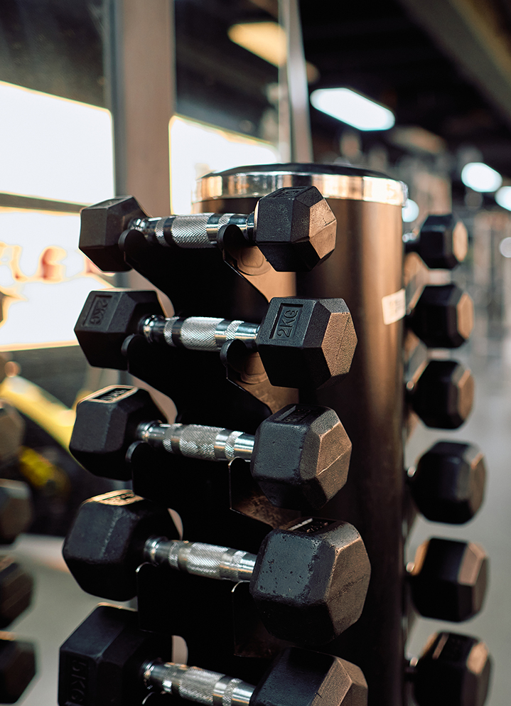 a black and silver dumbbells on a black stand