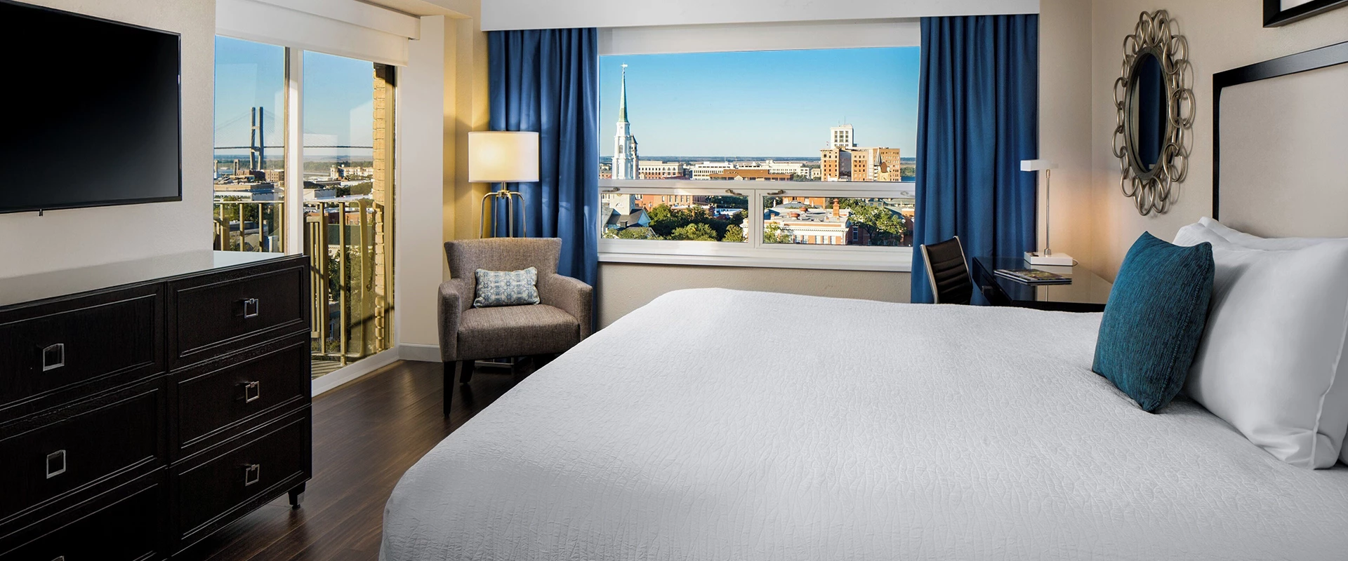 a hotel room with a large bed and a large window