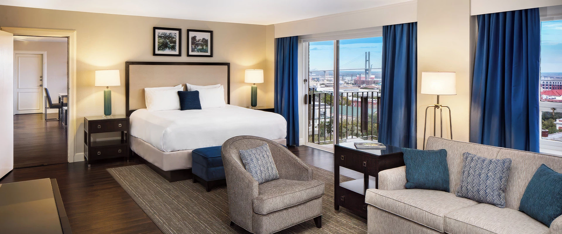a hotel room with a bed and chairs