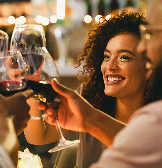 a group of people clinking wine glasses