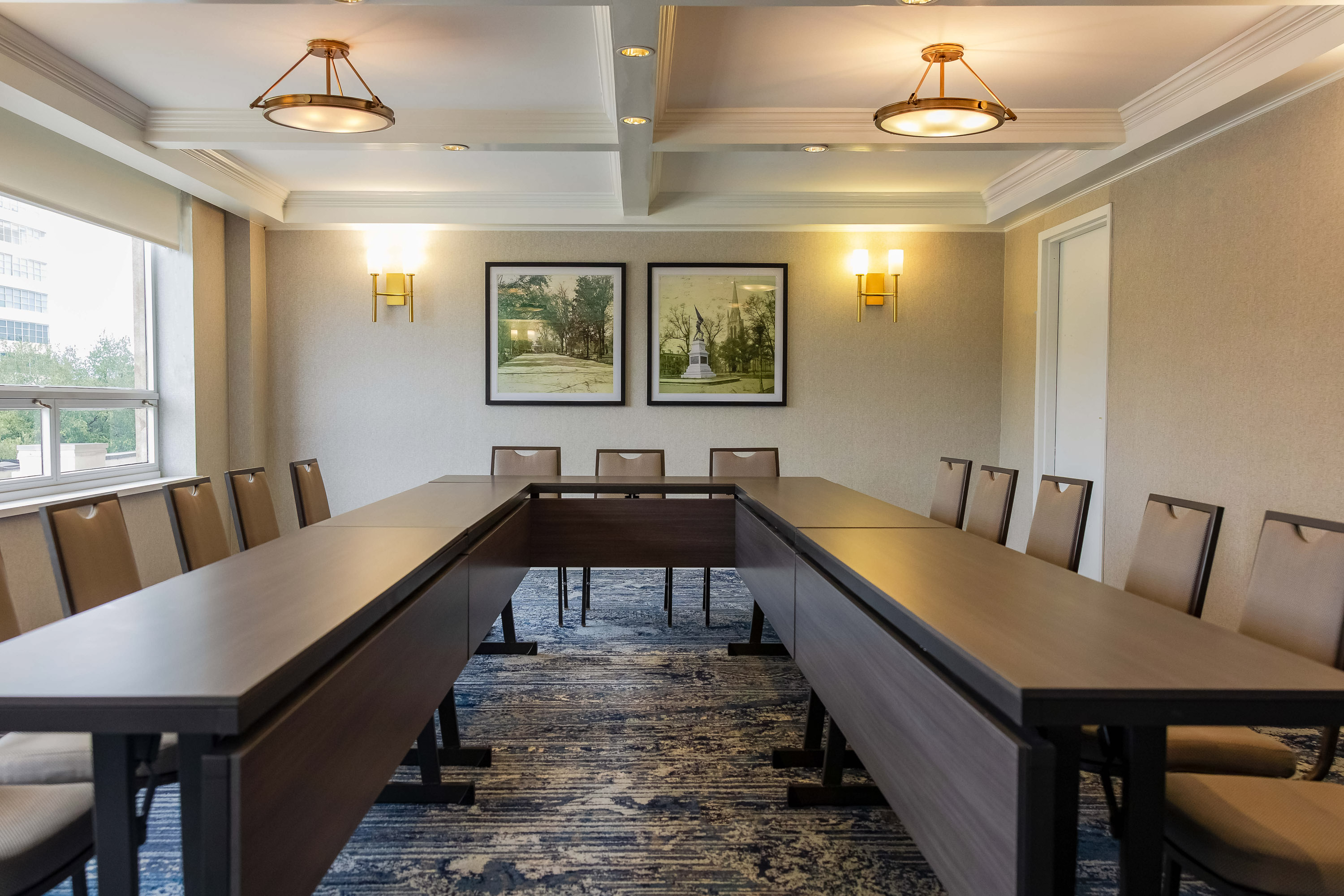a room with a long table and chairs
