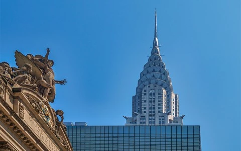 a tall building with a spire and a decorative roof