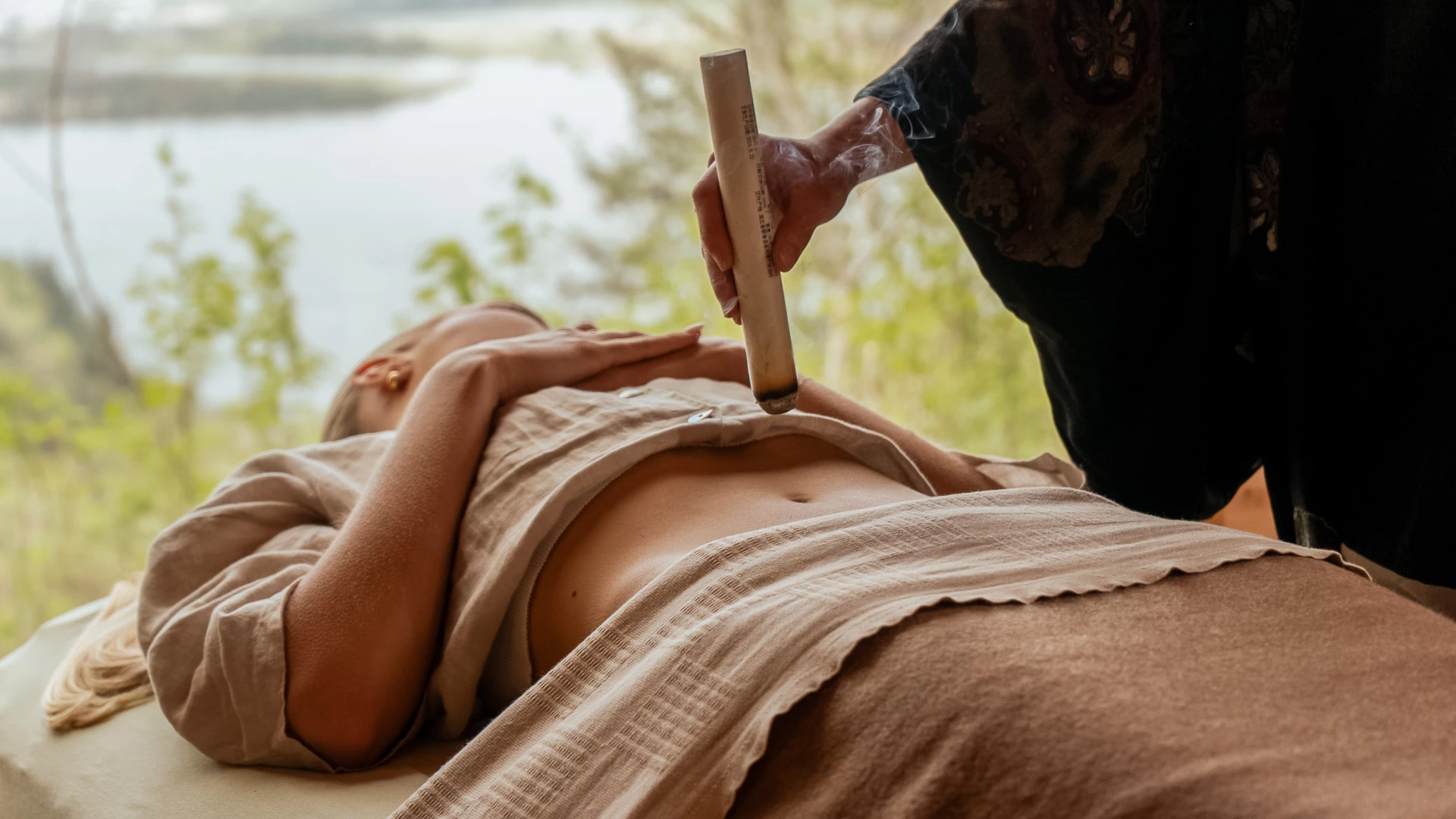 a person holding a stick to a woman's stomach