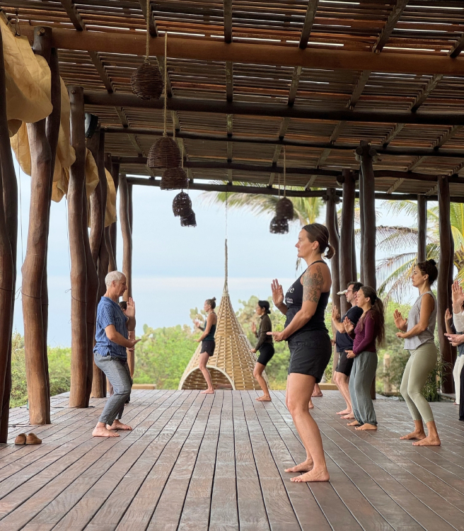 a group of people standing on a wooden deck