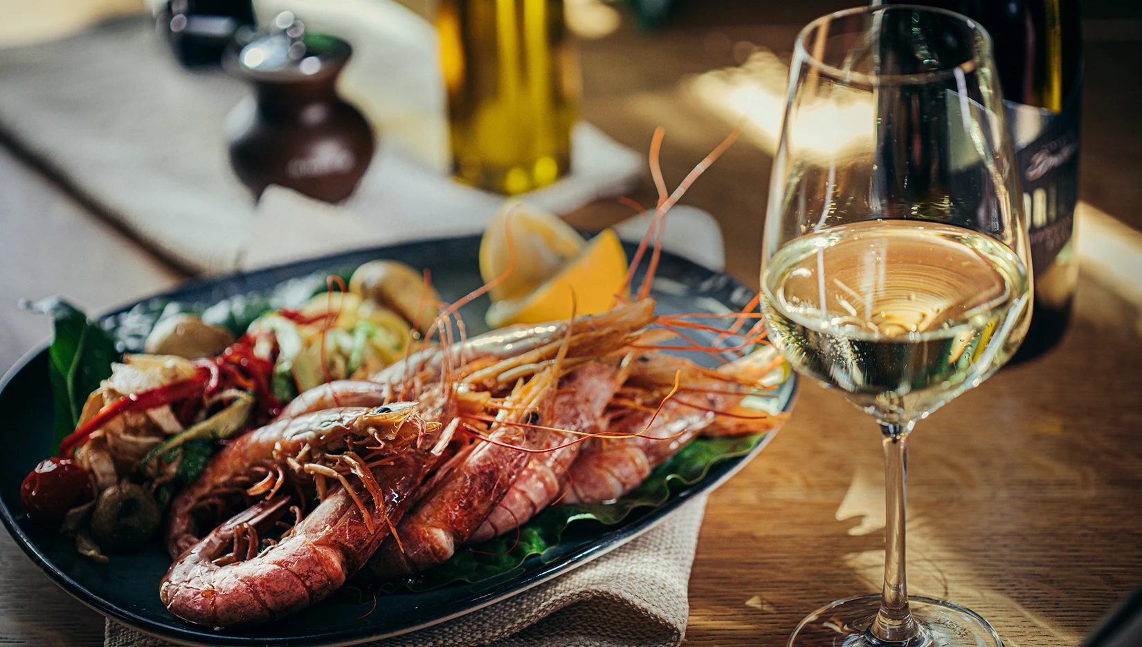 a plate of seafood and a glass of wine