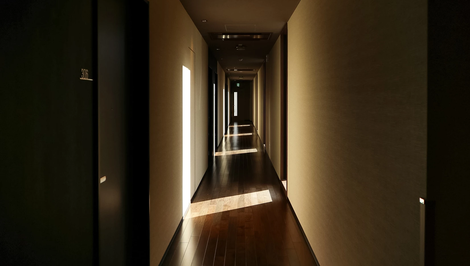 a long hallway with light coming through the walls