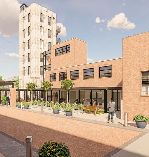 a building with a brick walkway and a man walking in front of it