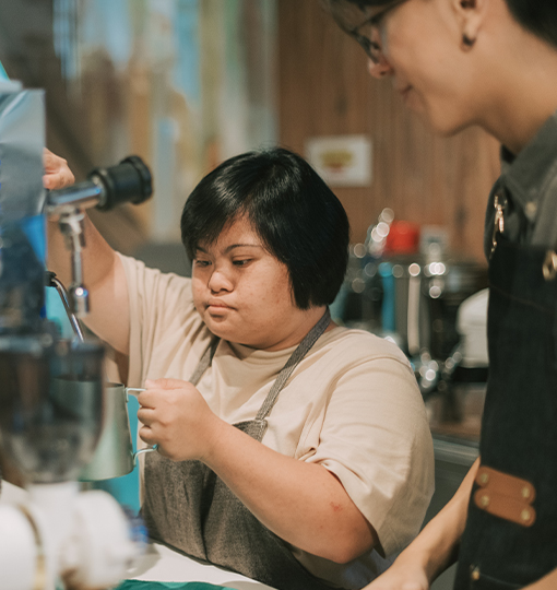 a woman working at a coffee machine