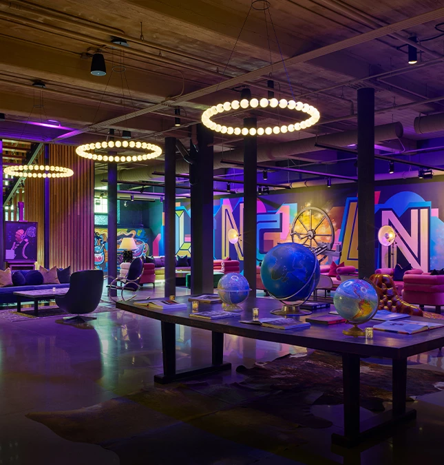 a room with a large table with globes and chairs