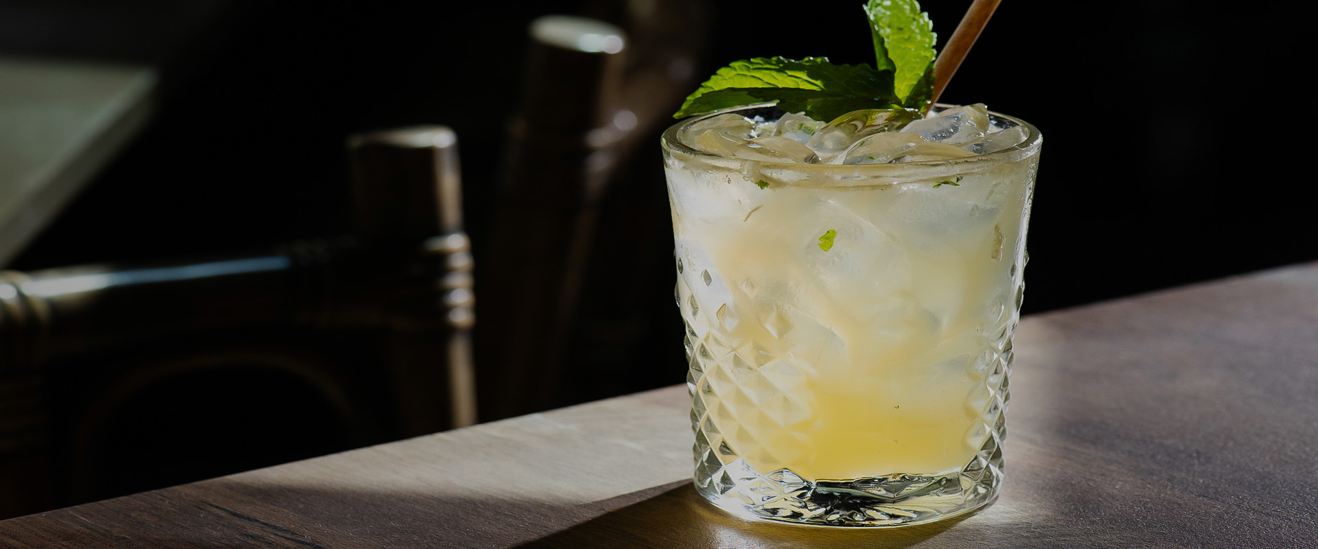 a glass with ice and mint leaves on it