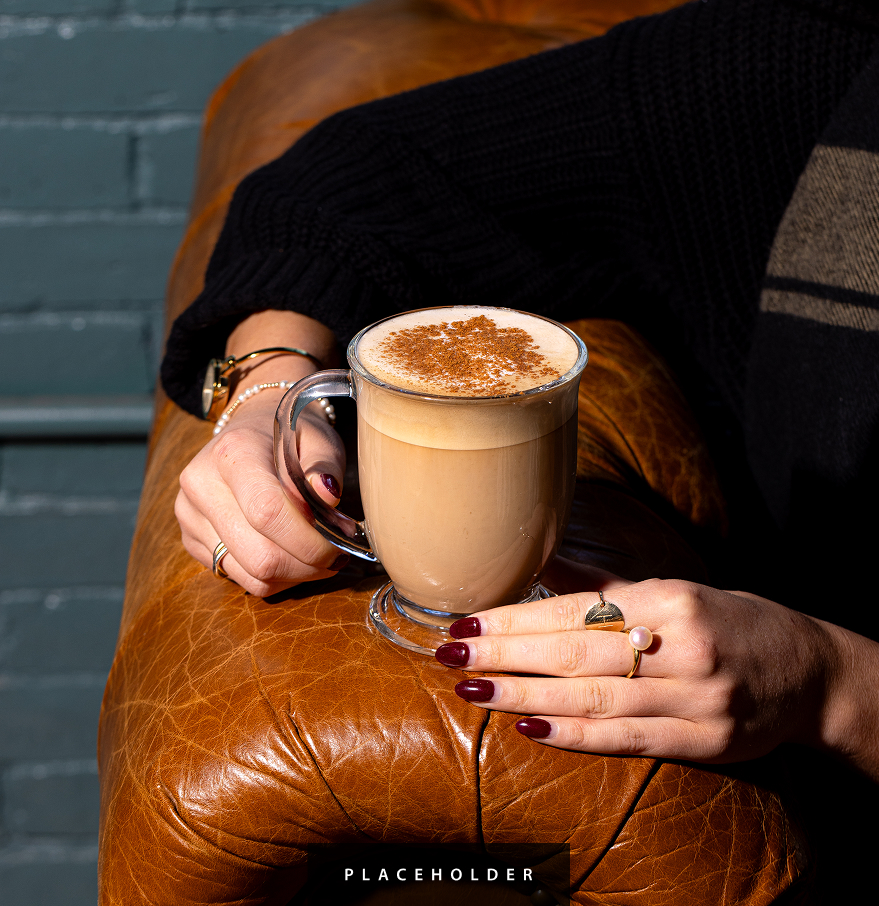 a person holding a cup of coffee