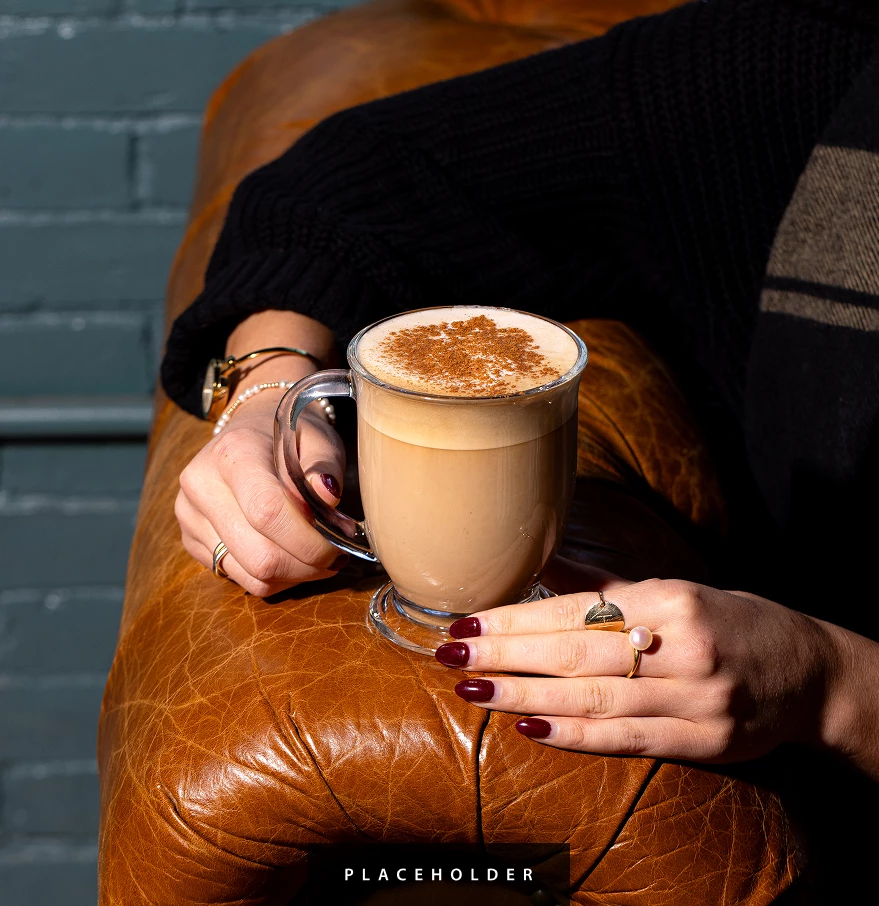 a person holding a cup of coffee