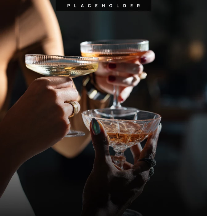 a group of hands holding glasses of alcohol