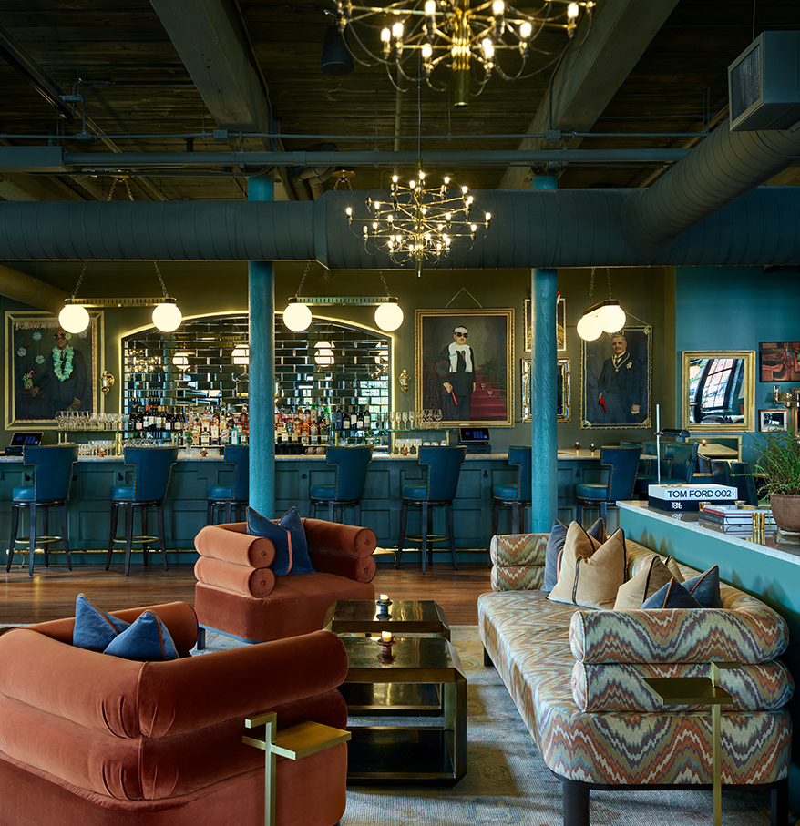 a room with a bar and a couch and chairs