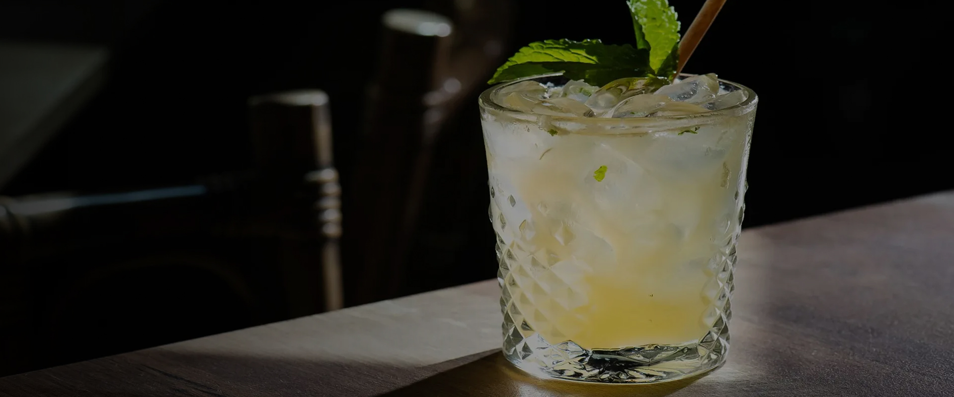 a glass with ice and mint leaves