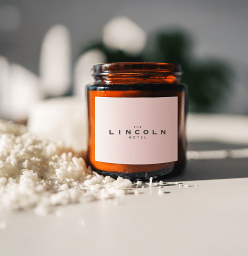 a glass jar with a white label next to a pile of white rice