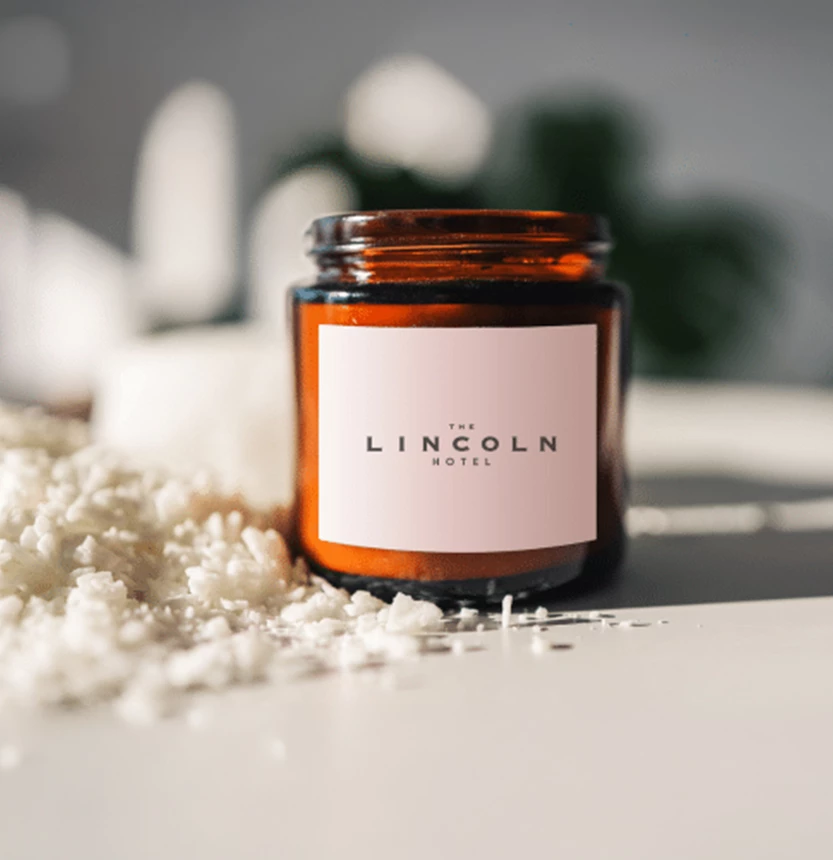 a glass jar with a white label next to a pile of white rice