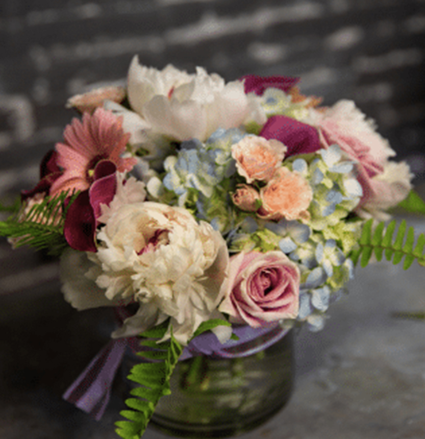 a bouquet of flowers in a glass vase
