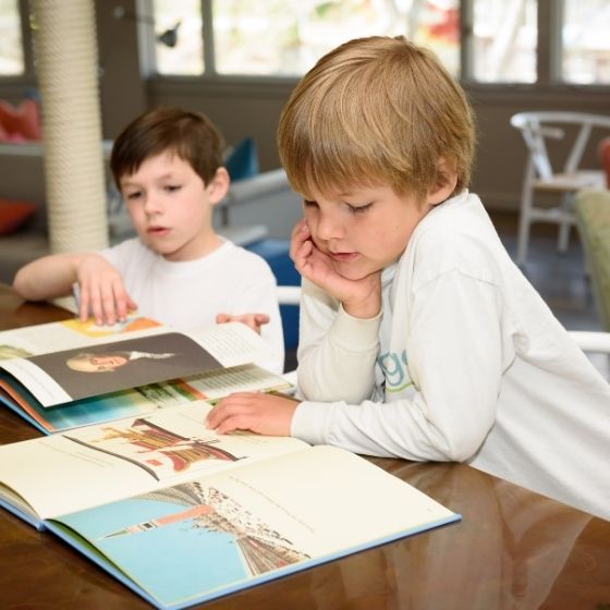 a couple of boys reading books