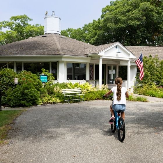 a girl riding a bike in front of a building