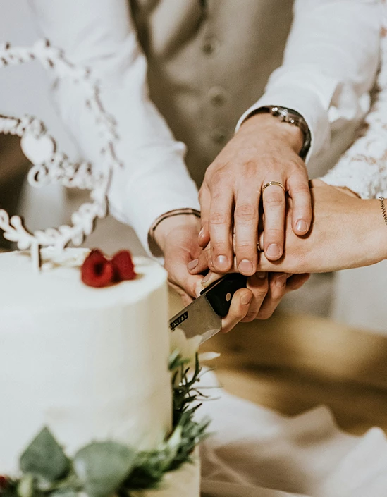 a man and woman cutting a cake