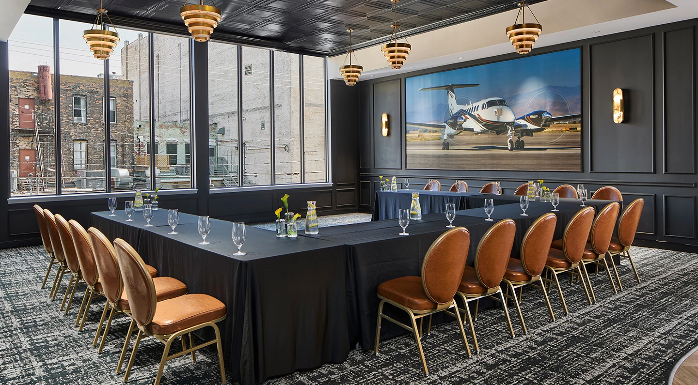 a room with black tablecloths and chairs