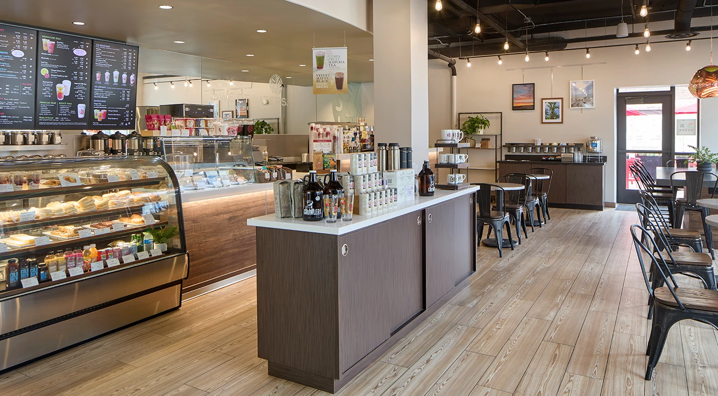 a coffee shop with a counter and shelves