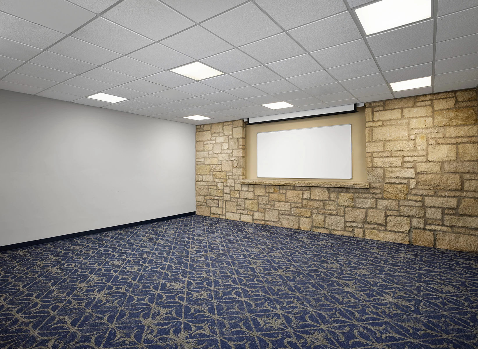a room with a stone wall and blue carpet