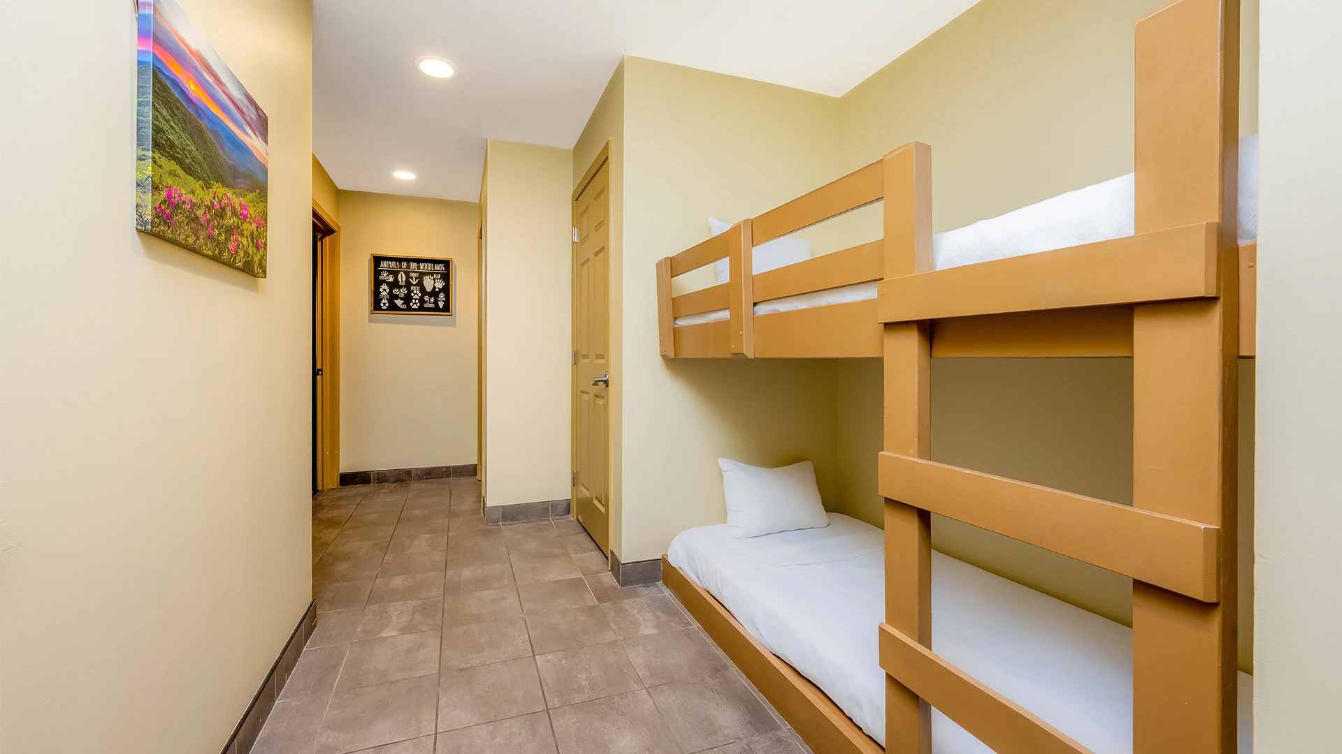 A room with a bunk bed and a tiled floor