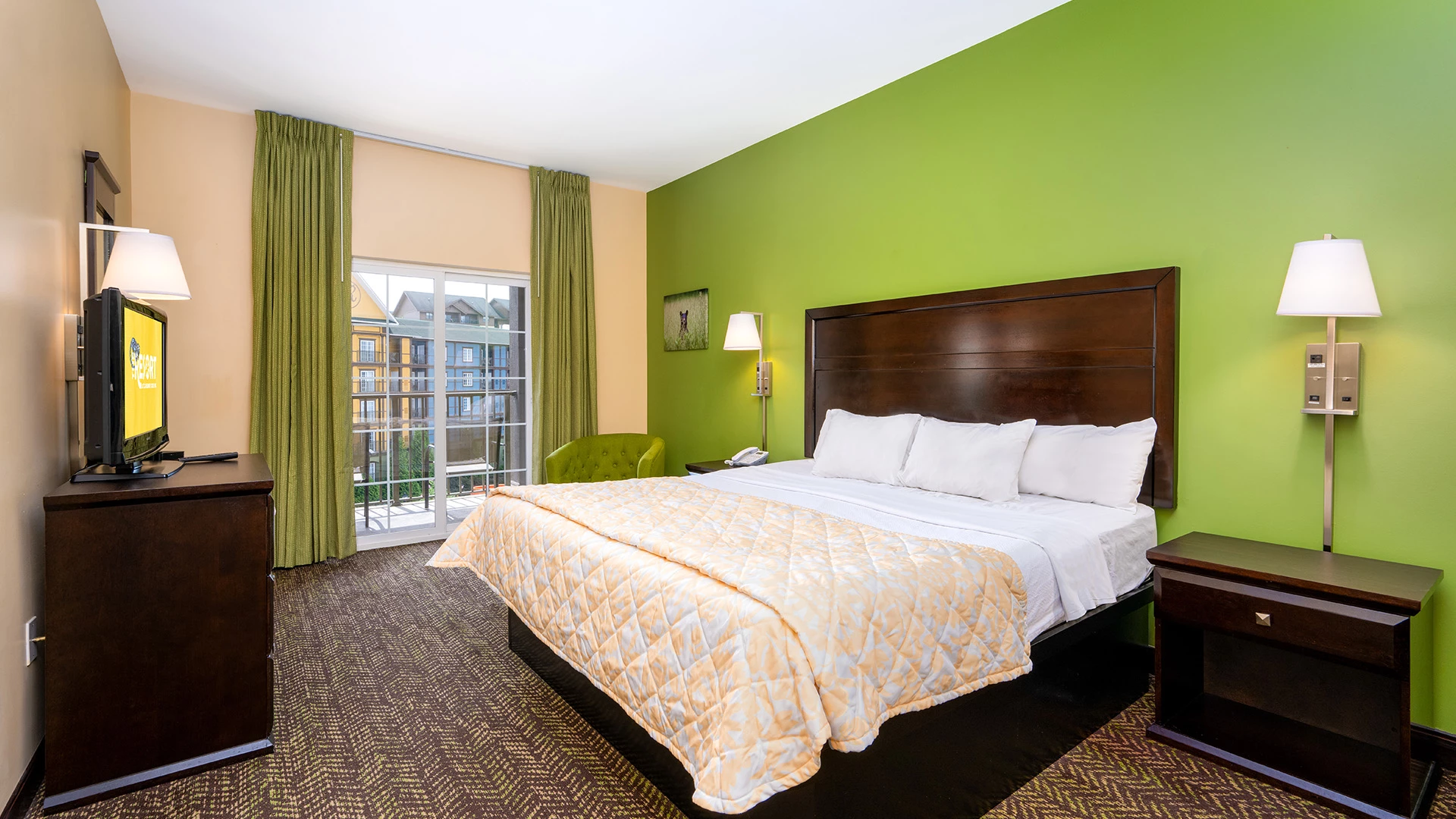 A hotel room with a large bed, TV, and window